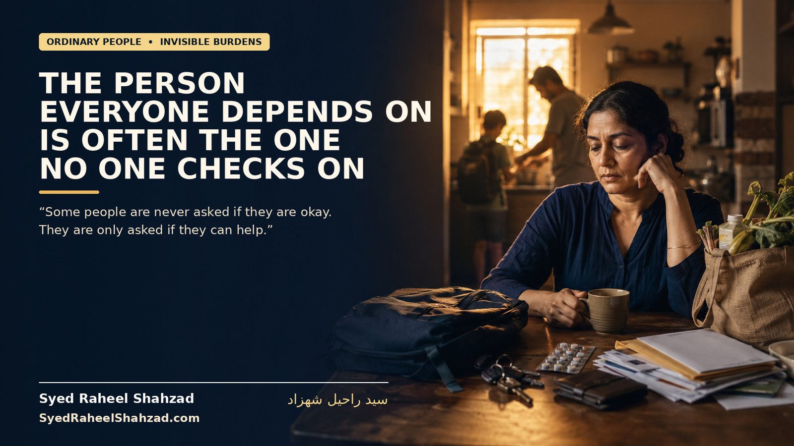 A dependable family member sits quietly at a kitchen table while household responsibilities continue around him, illustrating the unseen burden of the person everyone depends on.
